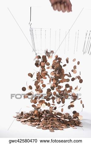 Stock Image - Coins draining from a metal basket. Fotosearch