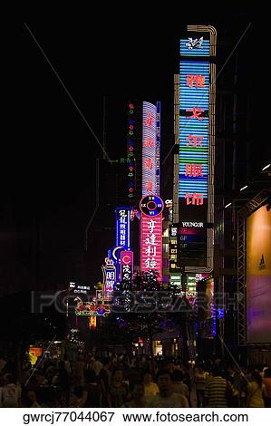 Stock Photo - Commercial signs lit up at night, Nanjing Road, Shanghai, China. Fotosearch