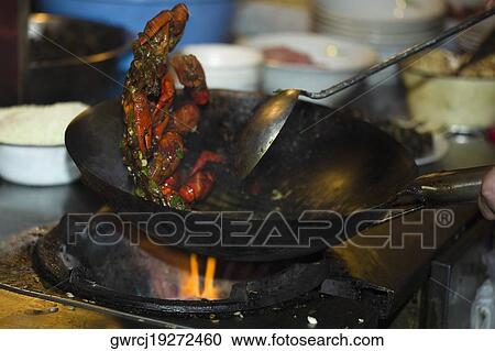 Stock Image - Crab cooking in a wok, Nanjing, Jiangsu Province, China. Fotosearch