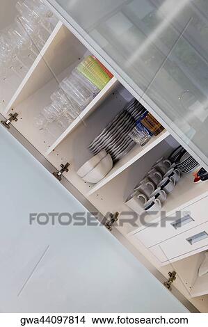 Picture - Crockery in a kitchen shelf. Fotosearch
