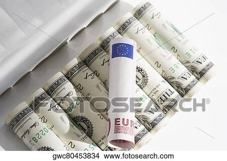 European union euro note on rolls of US paper currency View Large Photo Image Picture - European union euro note on rolls of US paper currency. Fotosearch