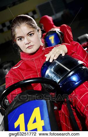 Female go-cart racer sitting in a sports car and thinking View Large Photo Image Stock Image - Female go-cart racer sitting in a sports car and thinking. Fotosearch