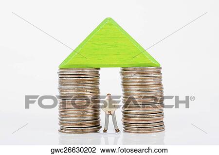 Stock Image - Figurine between two stacks of coins. Fotosearch