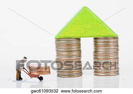 Figurine of a manual worker carrying coins on a wheelbarrow View Large Photo Image Stock Image - Figurine of a manual worker carrying coins on a wheelbarrow. Fotosearch