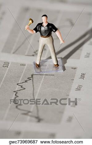 Figurine of a manual worker on a financial newspaper View Large Photo Image Stock Photo - Figurine of a manual worker on a financial newspaper. Fotosearch