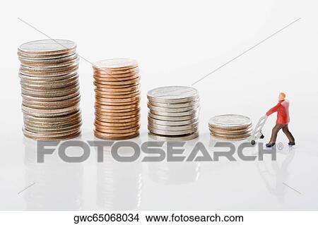 Figurine of a manual worker with stacks of coins View Large Photo Image Picture - Figurine of a manual worker with stacks of coins. Fotosearch