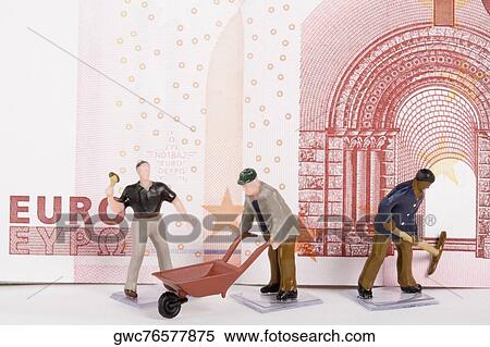 Figurines of manual workers in front of a European union euro note View Large Photo Image Stock Photography - Figurines of manual workers in front of a European union euro note. Fotosearch