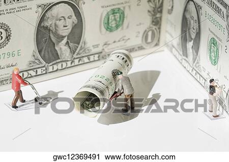 Figurines of manual workers with US dollar bills View Large Photo Image Stock Image - Figurines of manual workers with US dollar bills. Fotosearch