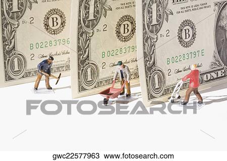 Figurines of manual workers with US dollar bills View Large Photo Image Stock Image - Figurines of manual workers with US dollar bills. Fotosearch