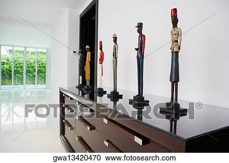 Stock Image - Figurines on a cabinet. Fotosearch
