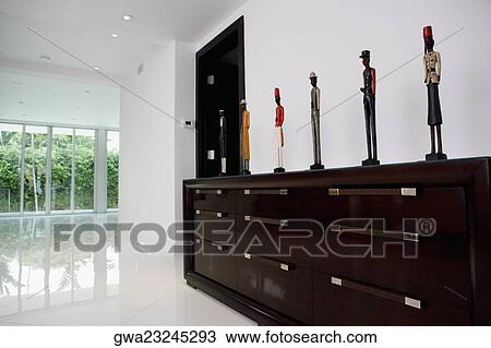 Stock Image - Figurines on a cabinet. Fotosearch