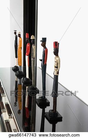 Stock Image - Figurines on a cabinet. Fotosearch