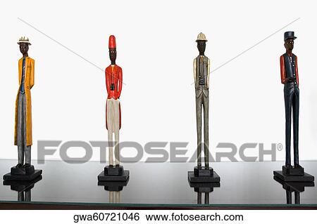 Stock Photograph - Figurines on a cabinet. Fotosearch