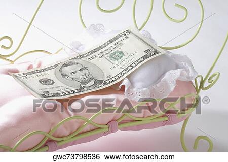 Five US dollar bill on a miniature bed View Large Photo Image Stock Photograph - Five US dollar bill on a miniature bed. Fotosearch