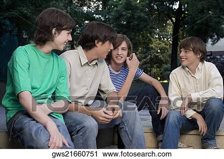 Stock Image - Four friends sitting together. Fotosearch