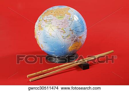 Globe with chopsticks View Large Photo Image Picture - Globe with chopsticks. Fotosearch
