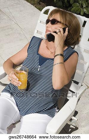 High angle view of a senior woman talking on a mobile phone View Large Photo Image Picture - High angle view of a senior woman talking on a mobile phone. Fotosearch