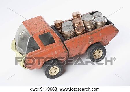 High angle view of a toy truck loading stacks of coins View Large Photo Image Stock Photo - High angle view of a toy truck loading stacks of coins. Fotosearch