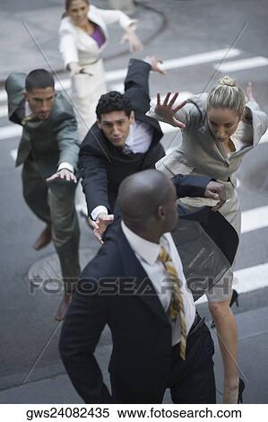High angle view of business executives chasing a businessman View Large Photo Image Stock Photography - High angle view of business executives chasing a businessman. Fotosearch