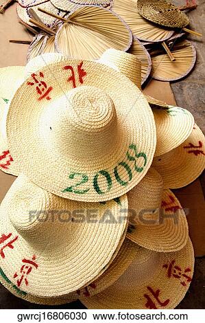 High angle view of hats and hand fans at a market stall, Xingping, Yangshuo, Guangxi Province, China View Large Photo Image Stock Image - High angle view of hats and hand fans at a market stall, Xingping, Yangshuo, Guangxi Province, China. Fotosearch