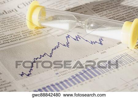 Hourglass on a financial newspaper View Large Photo Image Stock Image - Hourglass on a financial newspaper. Fotosearch