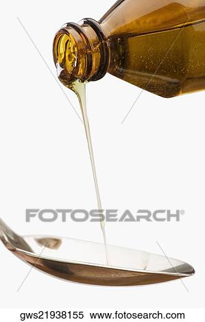 Stock Photography - Liquid medicine pouring into spoon. Fotosearch