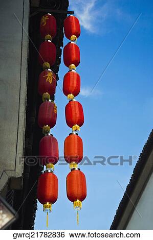 Low angle view of Chinese lanterns hanging on a building, Tunxi Old Street, Anhui Province, China View Large Photo Image Stock Photograph - Low angle view of Chinese lanterns hanging on a building, Tunxi Old Street, Anhui Province, China. Fotosearch
