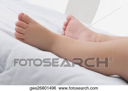 Stock Photograph - Low section view of a baby's legs. Fotosearch