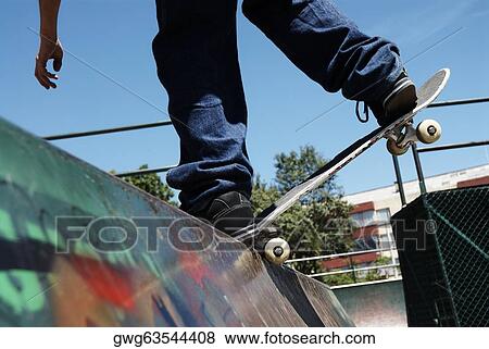 Low section view of a man skateboarding View Large Photo Image Stock Photo - Low section view of a man skateboarding. Fotosearch