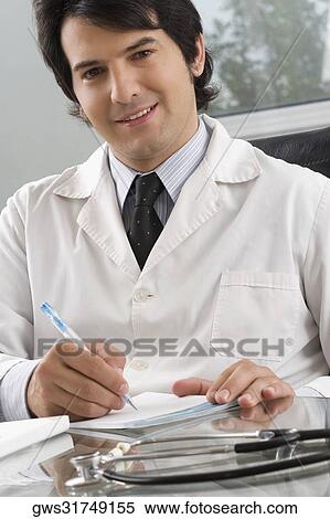 Male doctor writing on a notepad with a pen View Large Photo Image Stock Photography - Male doctor writing on a notepad with a pen. Fotosearch
