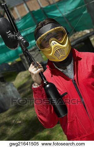 Stock Photography - Man holding a paintball gun. Fotosearch