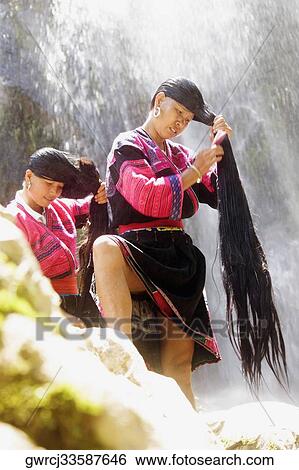 Mature woman and a mid adult woman combing their wet hair, Jinkeng Terraced Field, Guangxi Province, China View Large Photo Image Stock Photograph - Mature woman and a mid adult woman combing their wet hair, Jinkeng Terraced Field, Guangxi Province, China. Fotosearch