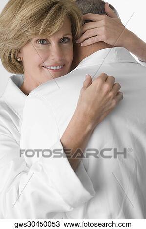 Mature woman and a senior man embracing each other View Large Photo Image Stock Image - Mature woman and a senior man embracing each other. Fotosearch