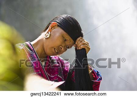 Mature woman holding her wet hair, Jinkeng Terraced Field, Guangxi Province, China View Large Photo Image Stock Image - Mature woman holding her wet hair, Jinkeng Terraced Field, Guangxi Province, China. Fotosearch