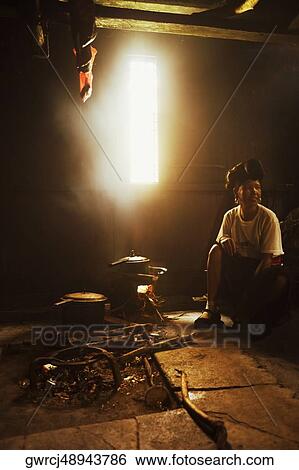 Stock Photograph - Mature woman preparing food, Jinkeng Terraced Field, Guangxi Province, China. Fotosearch