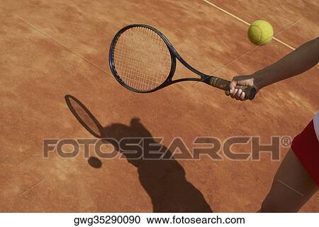 Mid section view of a female tennis player playing View Large Photo Image Stock Image - Mid section view of a female tennis player playing. Fotosearch