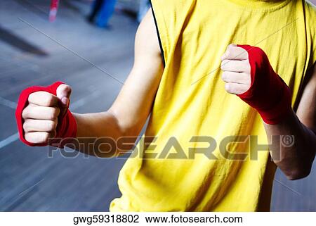 Mid section view of a male boxer wearing bandage in his both hands View Large Photo Image Stock Image - Mid section view of a male boxer wearing bandage in his both hands. Fotosearch
