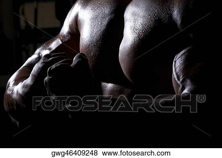 Stock Photo - Mid section view of a man flexing his muscles. Fotosearch