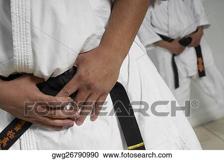 Mid section view of a man wearing karate uniform View Large Photo Image Stock Image - Mid section view of a man wearing karate uniform. Fotosearch