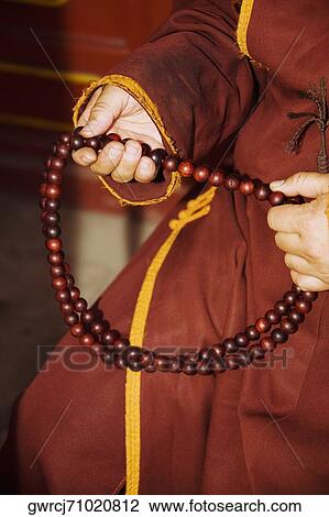 Mid section view of a person's hand holding a prayer beads, Da Zhao Temple, Hohhot, Inner Mongolia, China View Large Photo Image Stock Image - Mid section view of a person's hand holding a prayer beads, Da Zhao Temple, Hohhot, Inner Mongolia, China. Fotosearch