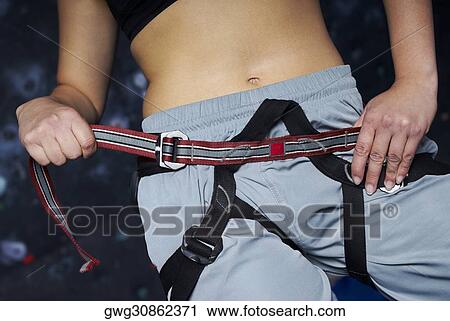 Mid section view of a woman preparing for rock climbing View Large Photo Image Stock Image - Mid section view of a woman preparing for rock climbing. Fotosearch