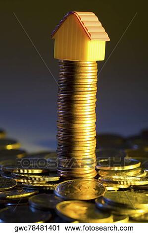 Model home on a stack of coins View Large Photo Image Stock Image - Model home on a stack of coins. Fotosearch