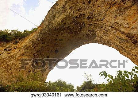 Stock Image - Natural arch formed at a hill, Moon Hill, Yangshuo, Guangxi Province, China. Fotosearch