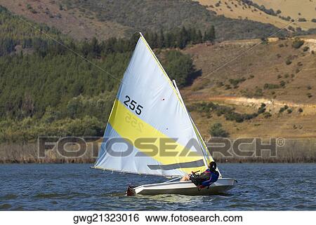 Stock Photograph - Person participating in a sailboat race. Fotosearch
