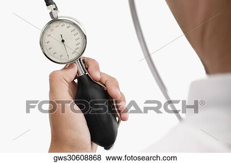 Person's hand holding a blood pressure gauge View Large Photo Image Stock Photo - Person's hand holding a blood pressure gauge. Fotosearch