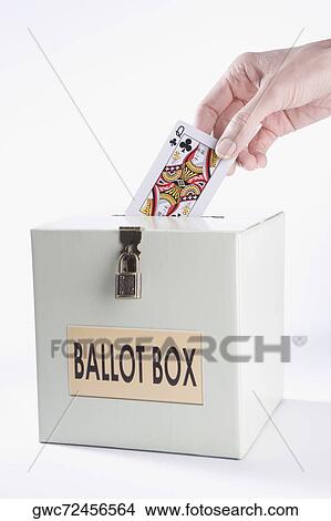 Person's hand inserting a playing card into a ballot box View Large Photo Image Picture - Person's hand inserting a playing card into a ballot box. Fotosearch