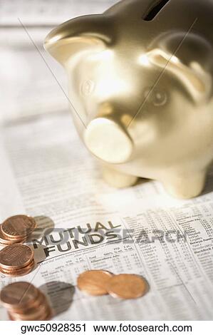 Piggy bank and coins on a financial newspaper View Large Photo Image Stock Image - Piggy bank and coins on a financial newspaper. Fotosearch