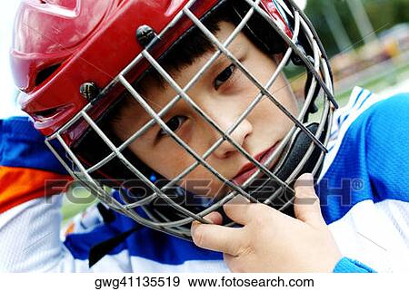 Portrait of a boy wearing an ice hockey helmet View Large Photo Image Stock Photo - Portrait of a boy wearing an ice hockey helmet. Fotosearch