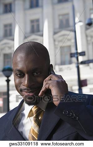 Portrait of a businessman talking on a mobile phone View Large Photo Image Stock Photo - Portrait of a businessman talking on a mobile phone. Fotosearch