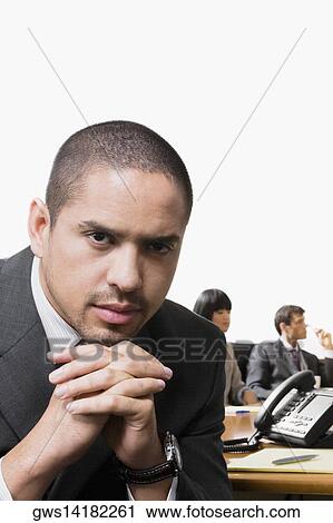 Portrait of a businessman thinking with other business executives in a board room View Large Photo Image Stock Image - Portrait of a businessman thinking with other business executives in a board room. Fotosearch